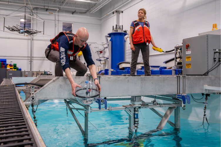 Members of the Drift-RMT prepare to test their buoy at the Chase Ocean Engineering Lab.